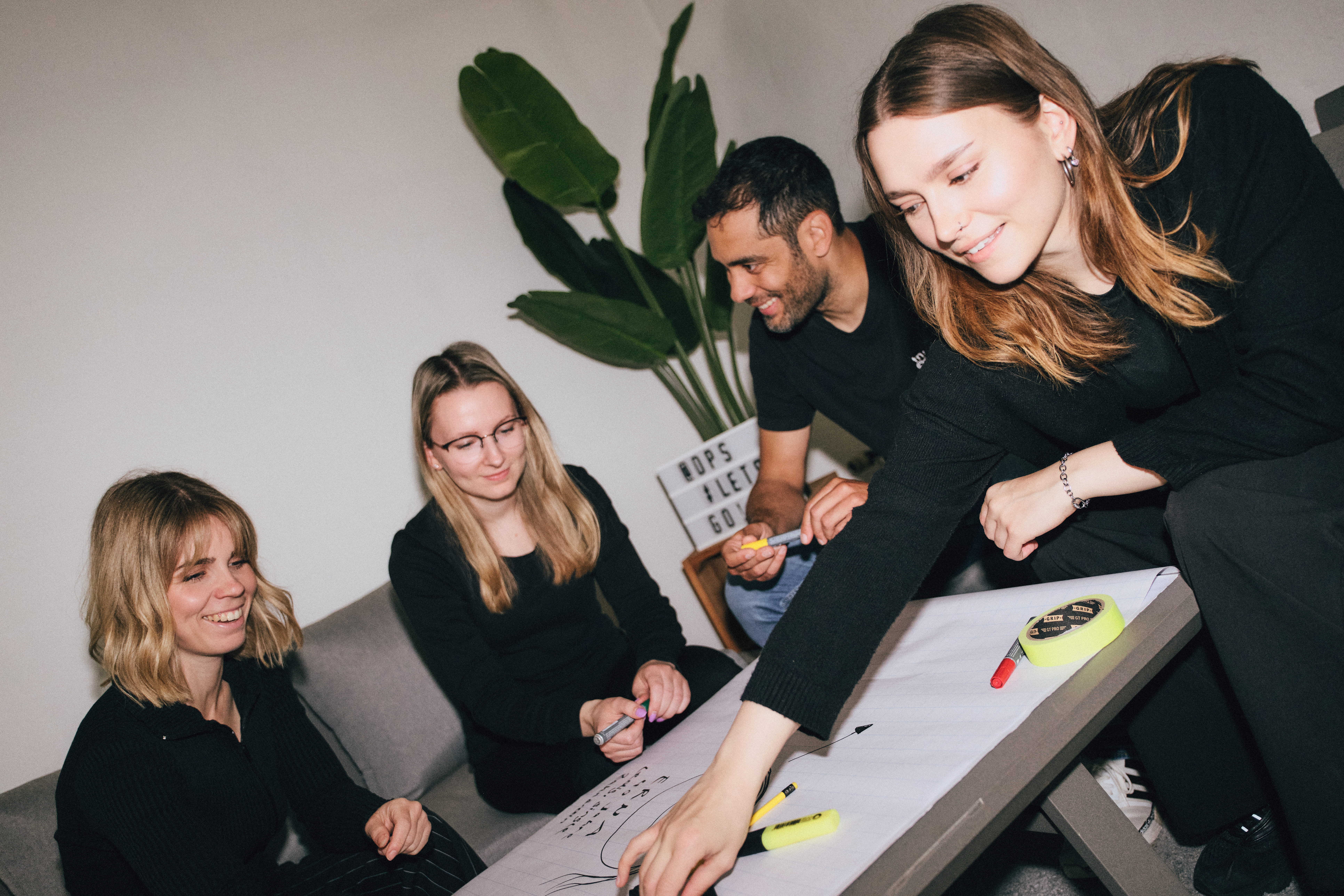 Team-die-projektscheune-3 Das Team sitzt gemeinsam an einem Tisch und erarbeitet sich ein Thema.